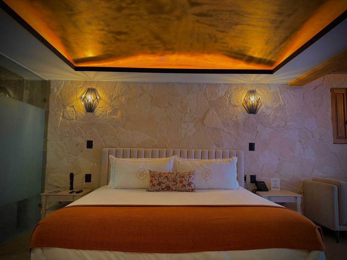Madera king suite with skyline views and a glowing gold-leaf ceiling