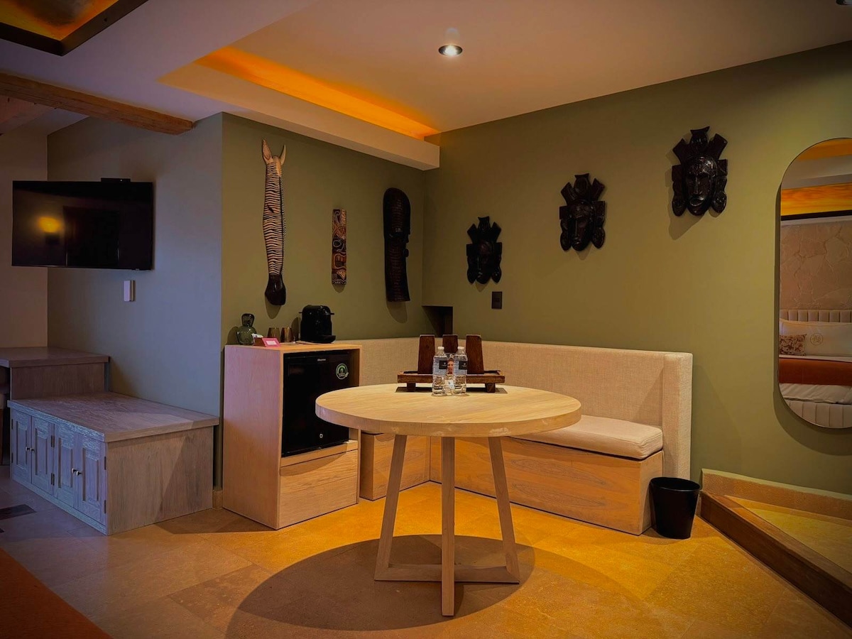 In-suite dining nook with a round table and banquette seating