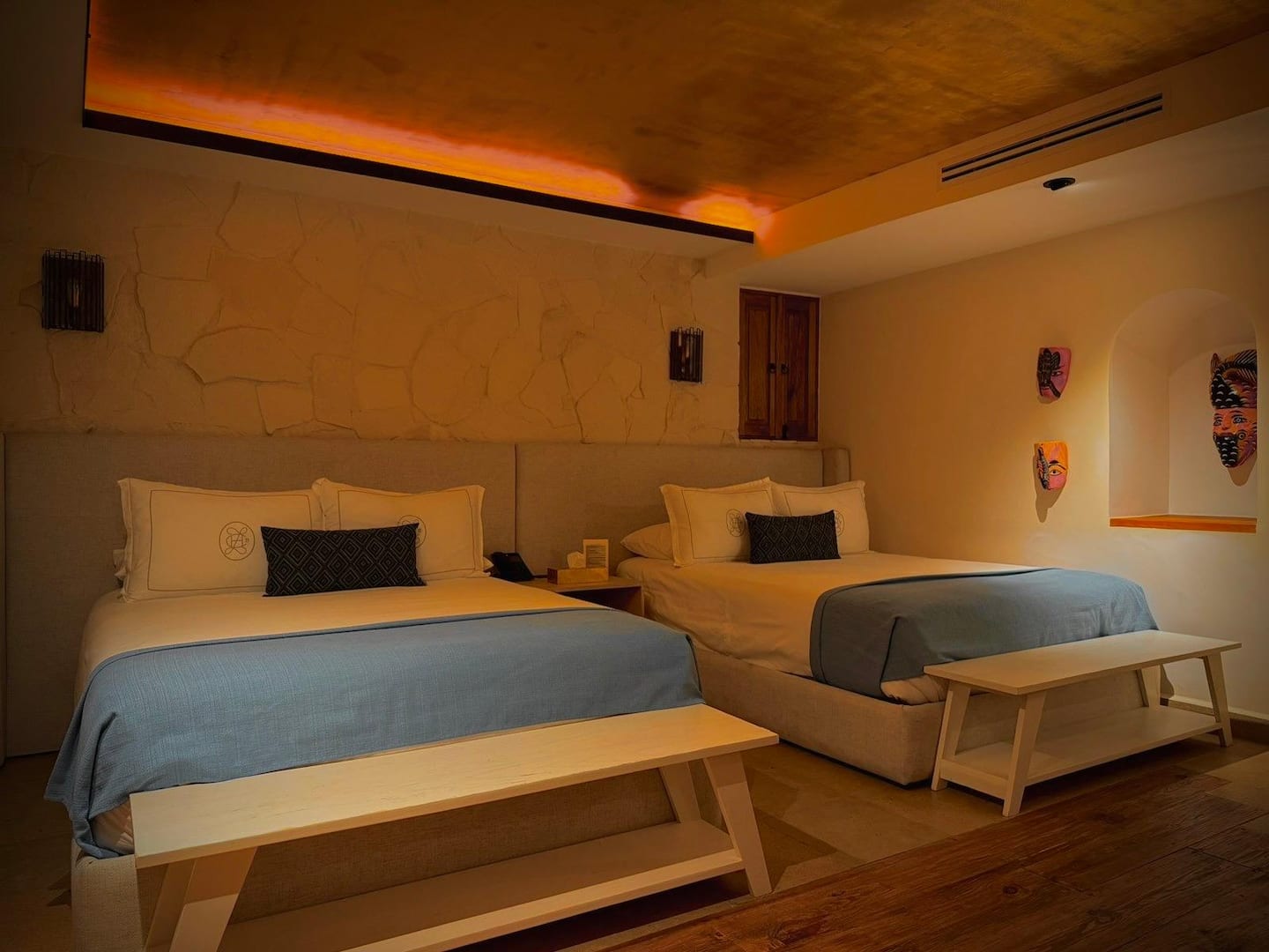 Papel Maché double queen room with two beds and artisan mask décor