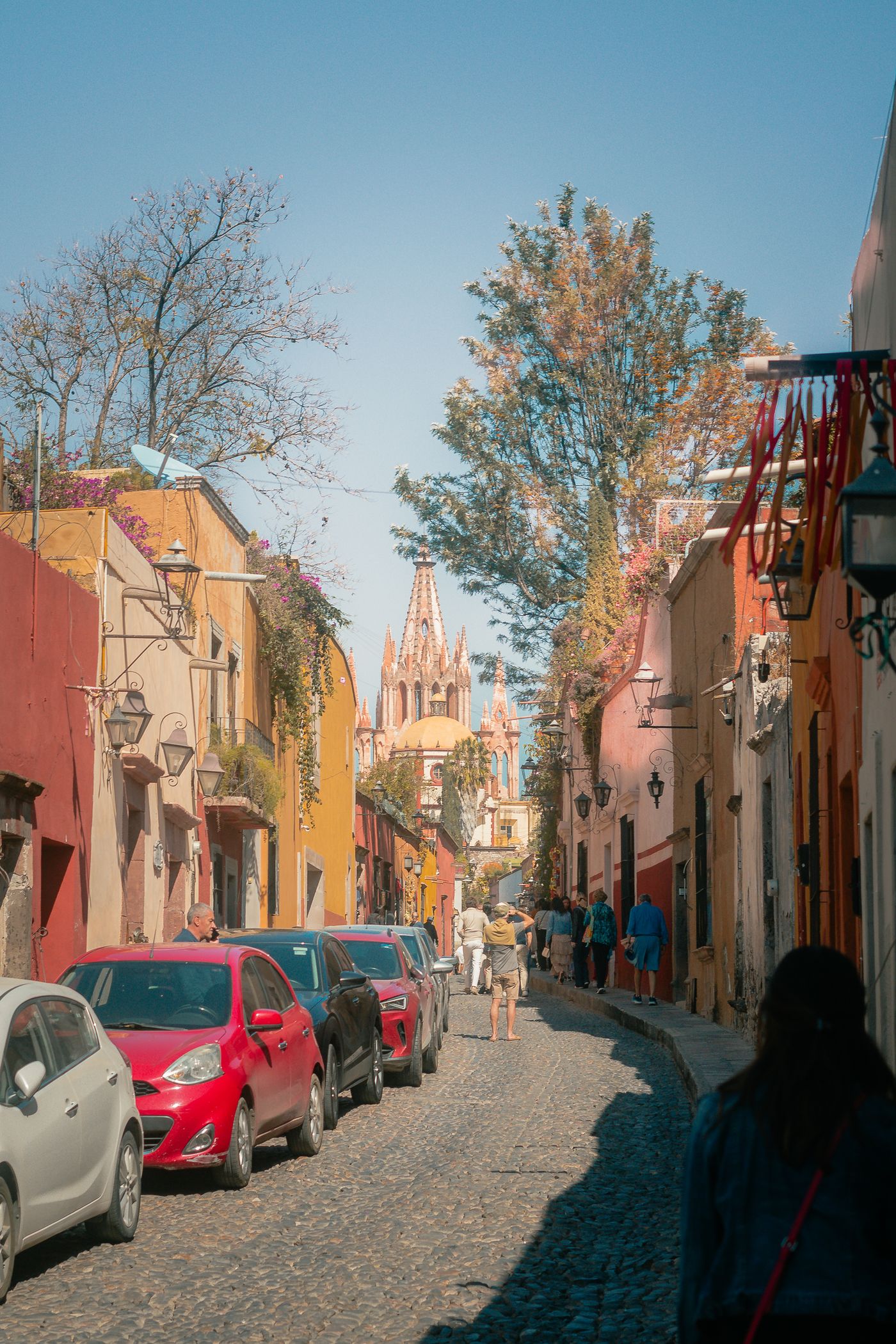 Cobblestone street with colorful facades leading to the Parroquia