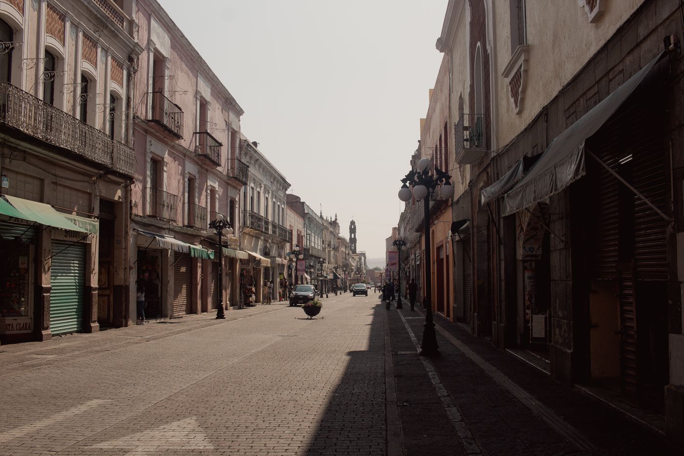 A colonial shopping street lined with artisan storefronts