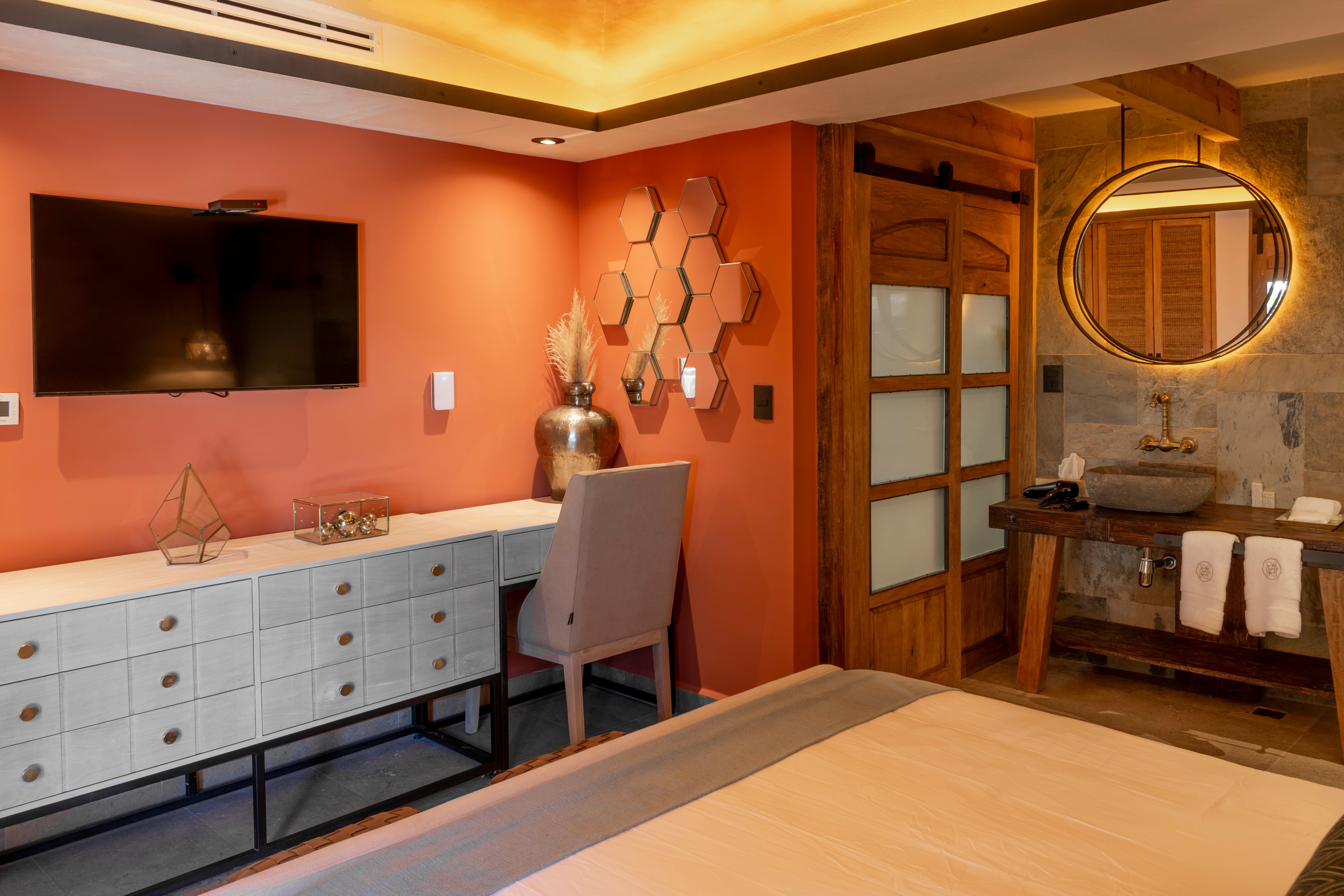 Suite interior in terracotta with a designer vanity and round mirror