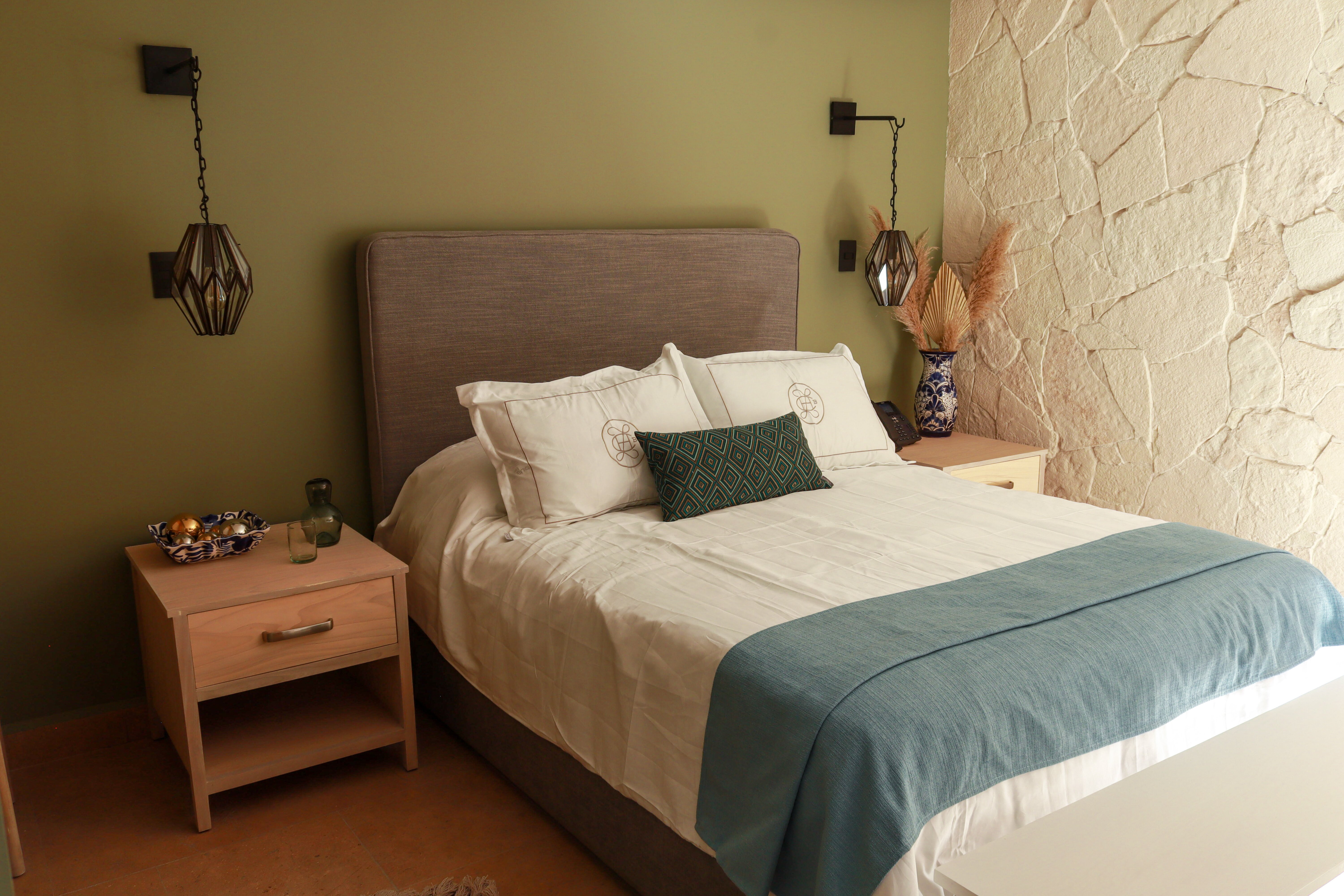 Room in olive tones with a limestone accent wall