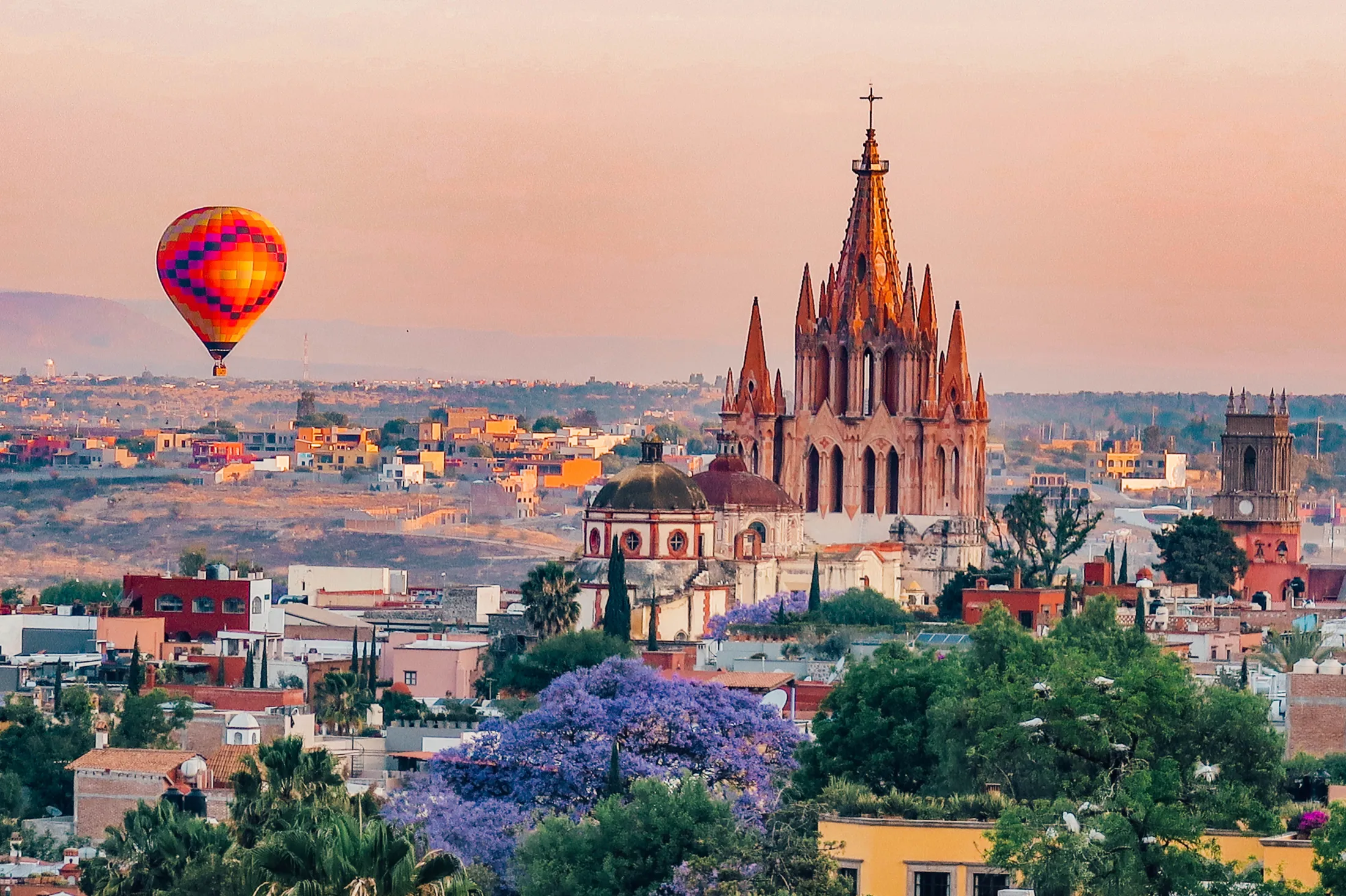 Sunrise over San Miguel with a hot air balloon and the Parroquia