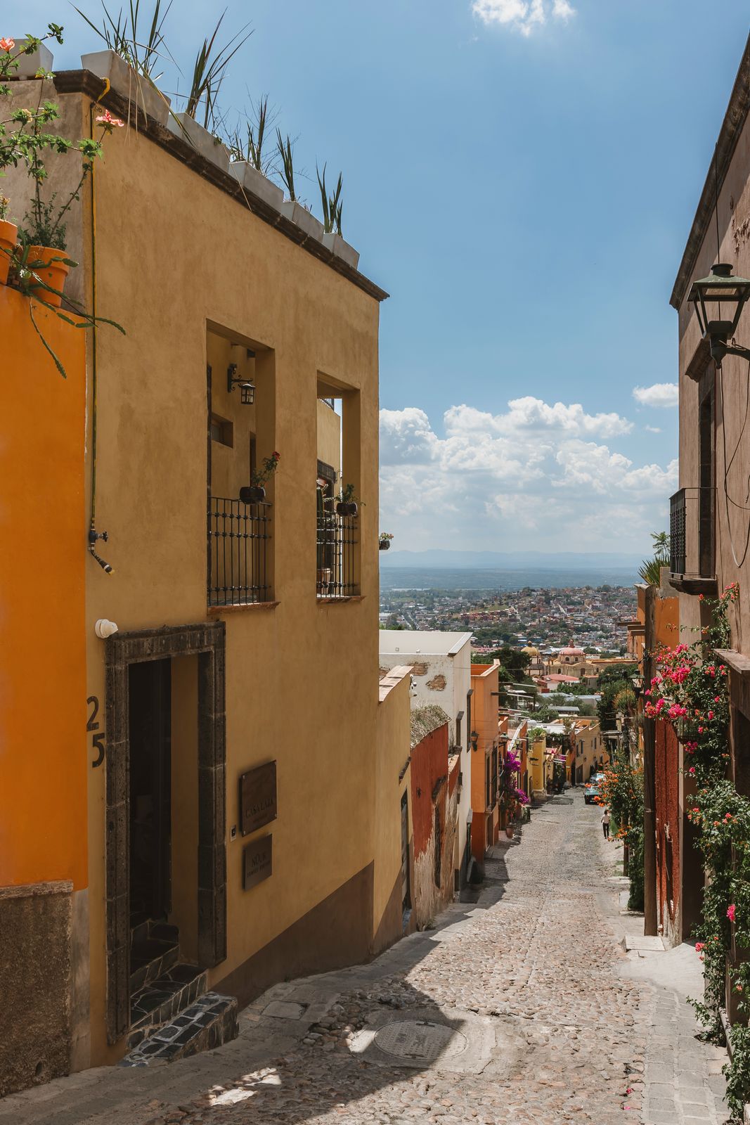 The colonial street outside Casa Laja, with the valley opening up beyond the rooftops